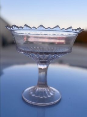 This is a vintage pressed clear pink glass pedestal bowl or candy dish.